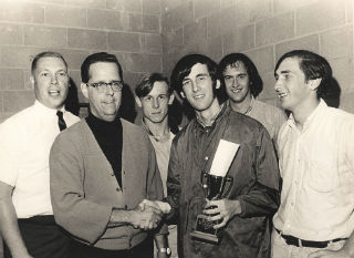 (L to R) Bob Darbee and Bob Dyer congratulate the winners of a Battle of the Bands competition at Roll-Air