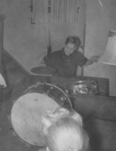 Young Joey playing his father's drum kit in the basement
