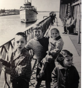 Kids ride the bridge span as a ship passes through