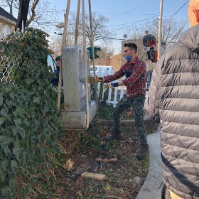 Mike Sullis and his father removing the tombstone